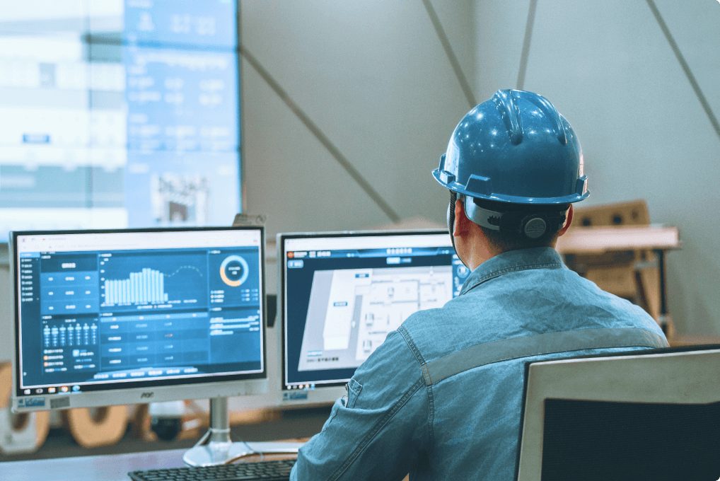 Engineer watching condition-monitoring dashboards in a control room