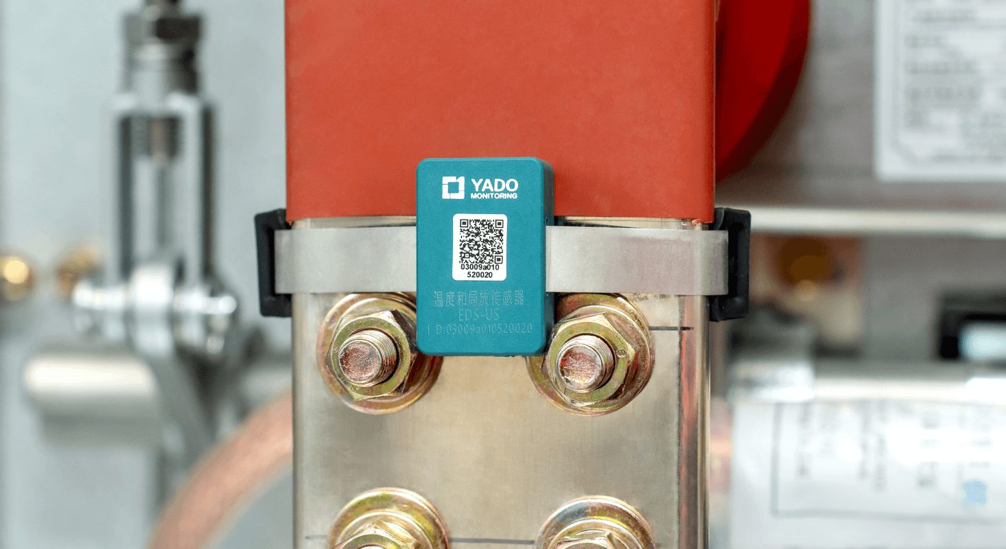 Yado PD Thermal Tag clamped on a medium-voltage busbar joint